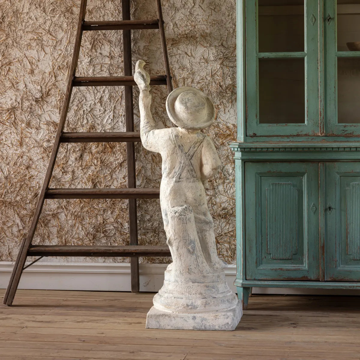 Farm Boy With Bird Statue